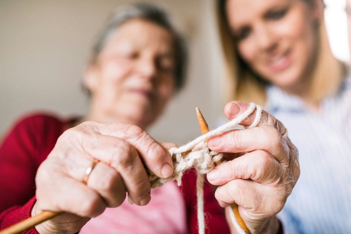 Close-up of hands learning to knit